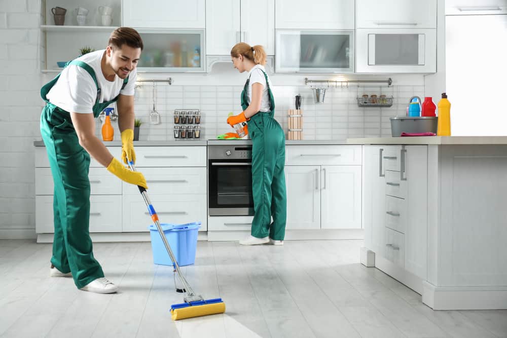 Cleaning Service Team At Work In Kitchen